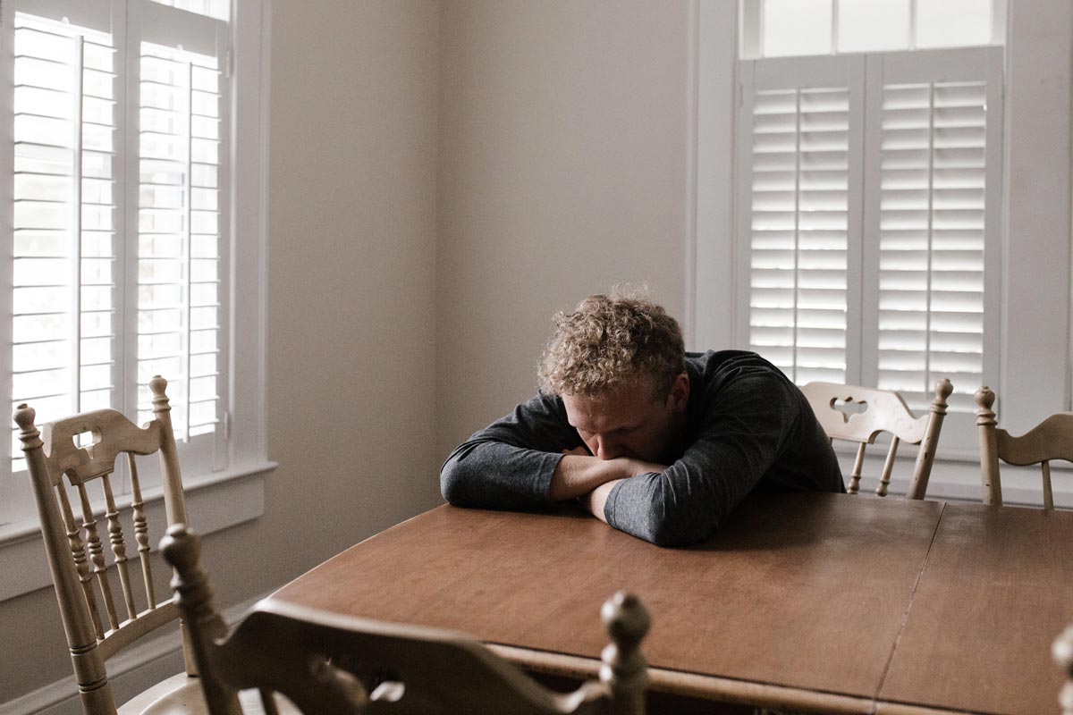 Man sitting with his head on the table